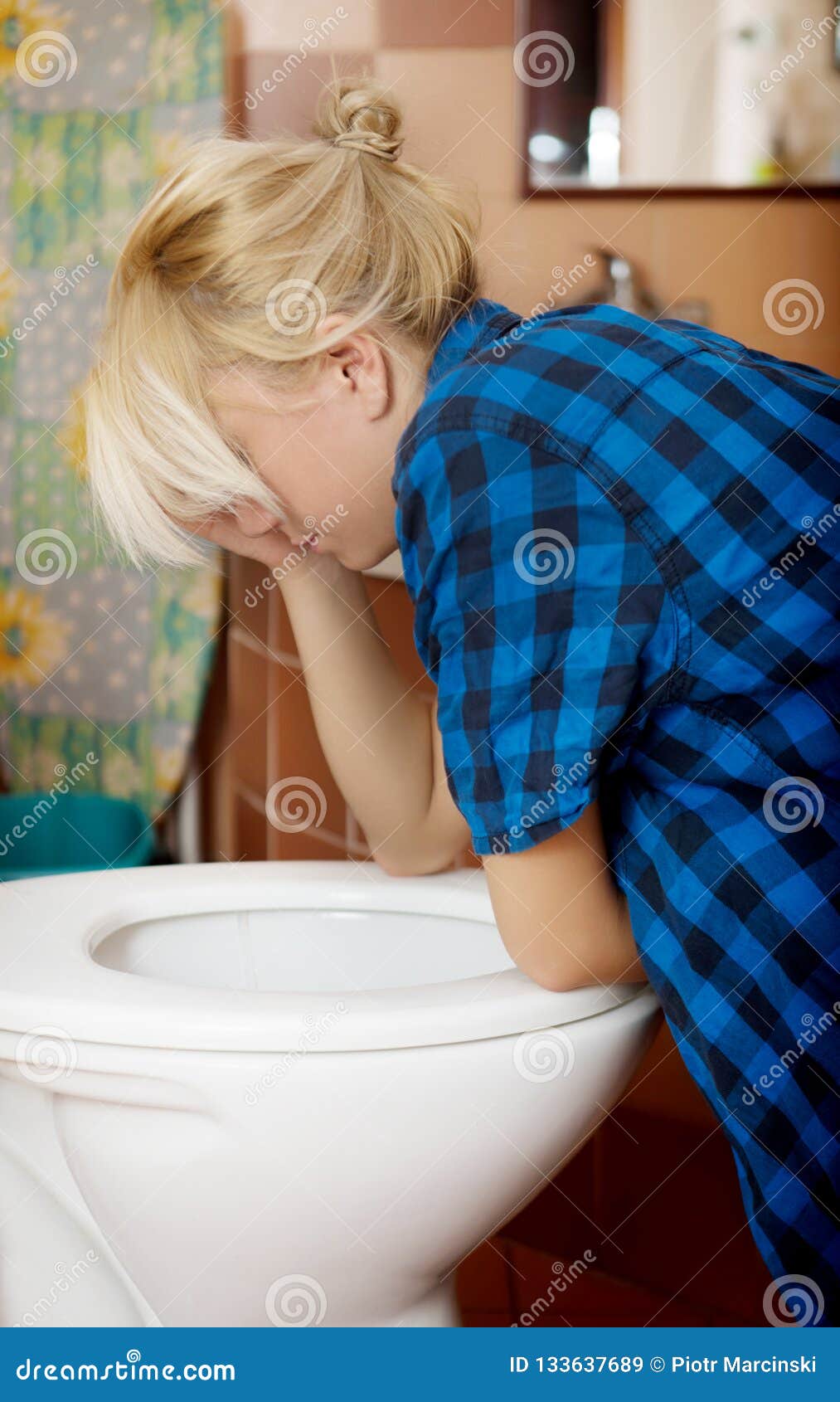 Sick Young Woman Leaning On Open Toilet Seat. Stock Photo 
