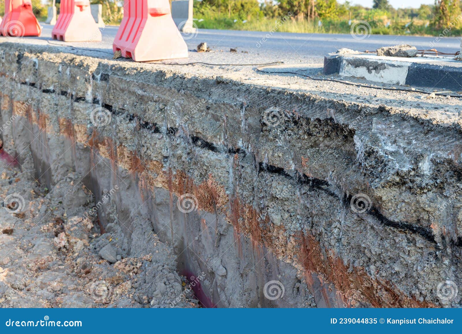 side of the broken asphalt road collapsed and fallen. road collapses. layer of soil beneath section. cracked asphalt road. constru