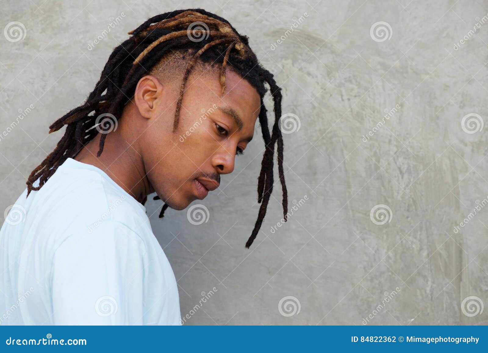 side portrait of african man with dreadlocks in contemplation