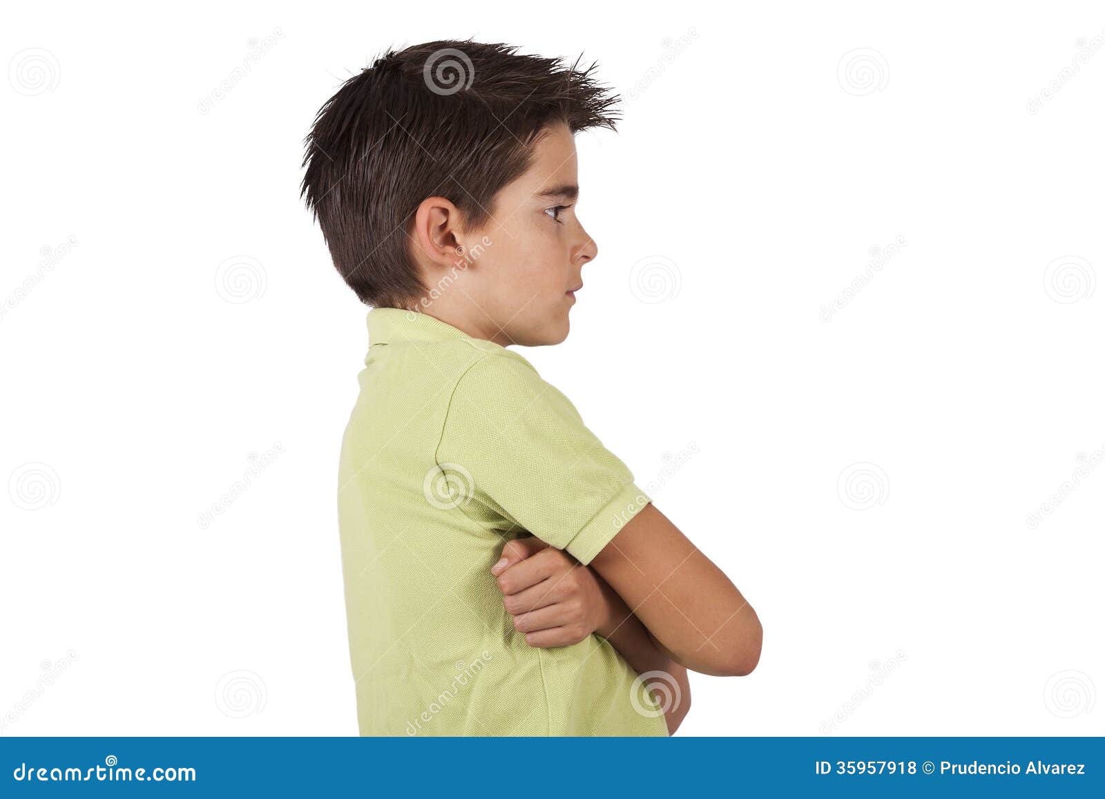 Side portrait of boy with arms crossed