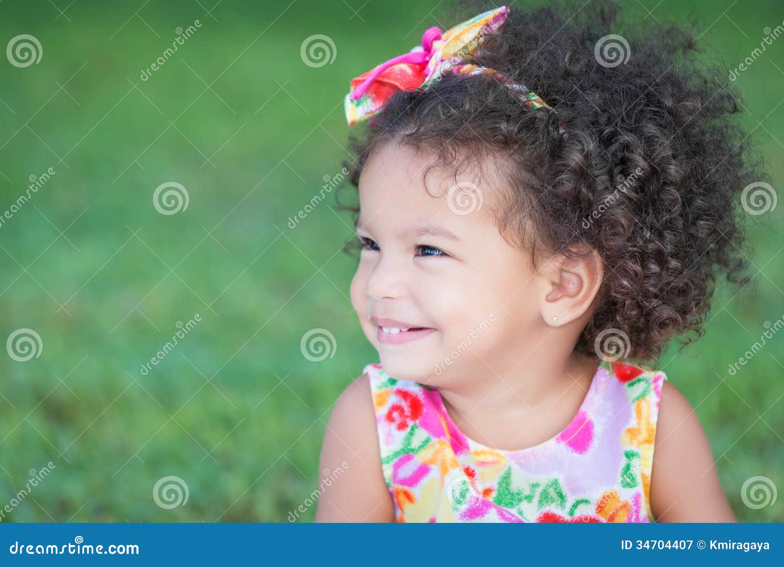 Side Portrait Of A Small Hispanic Girl With An Afro 