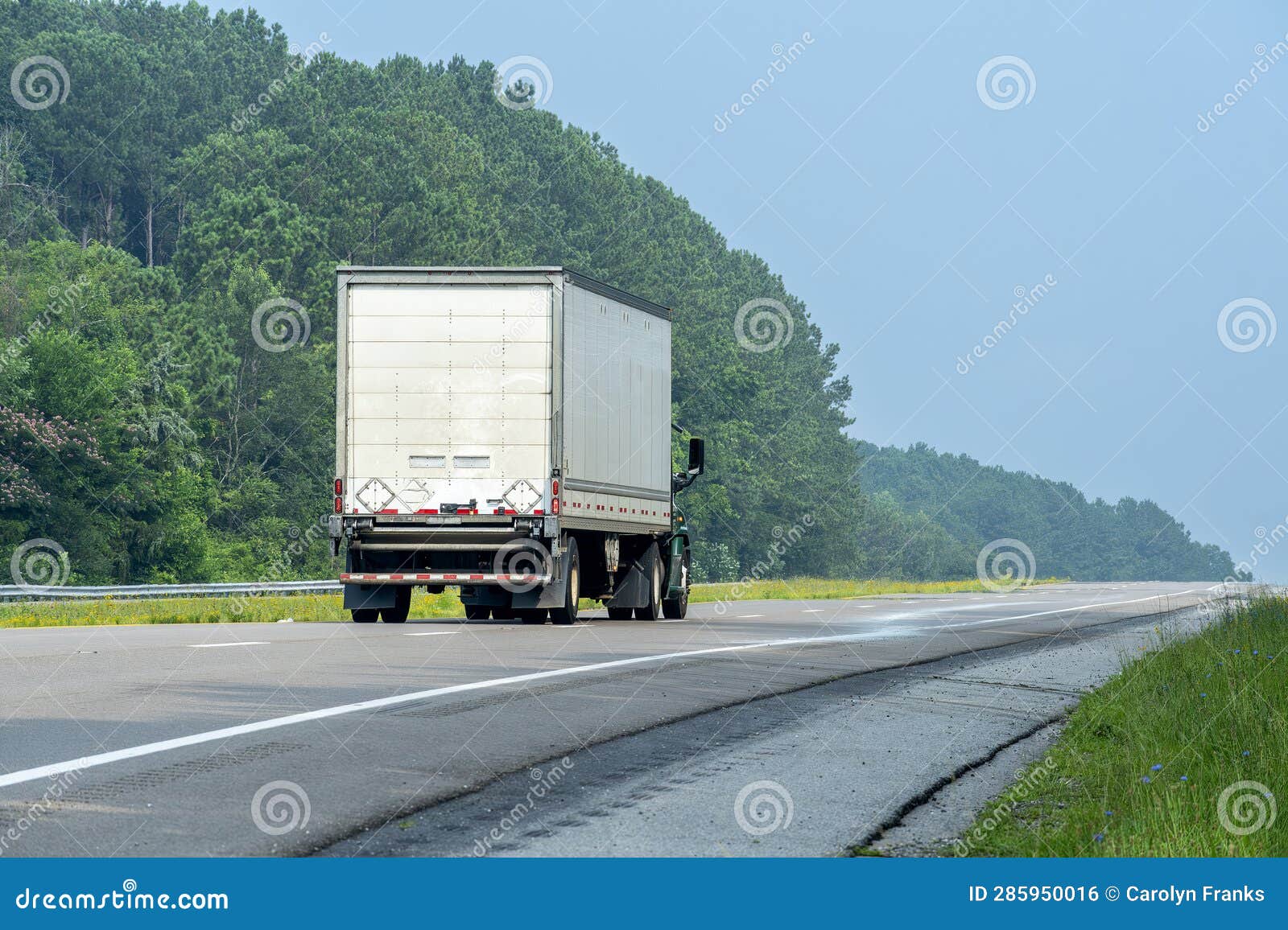 SideRear View of Eighteen Wheeler Going Down the Interstate Stock