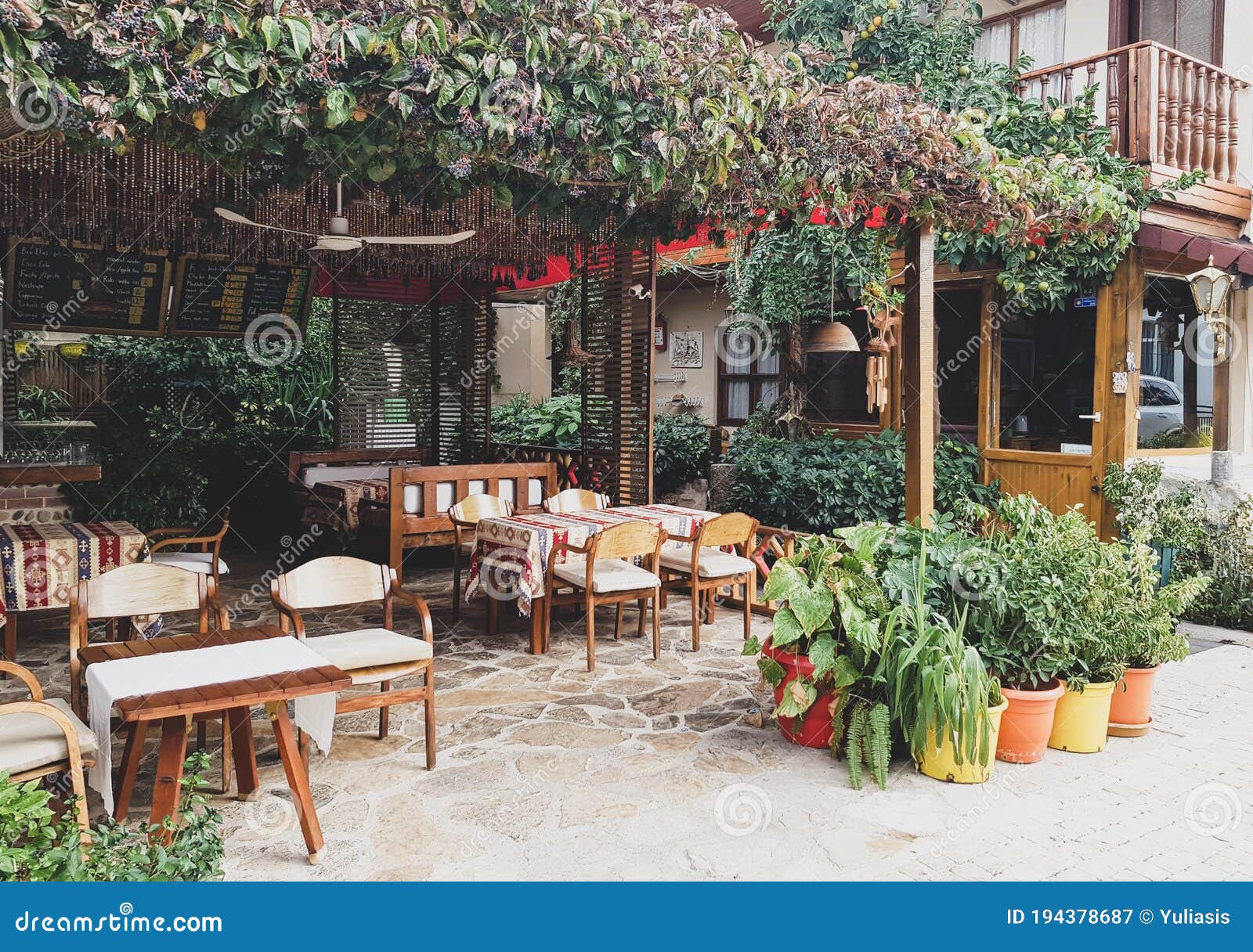Side, Turkey, November 2019: Rustic Outdoor Cafe, with Wooden Tables and  Chairs, Wrapped in Wild Grapes and Next To the Sea. No Editorial  Photography - Image of design, house: 194378687