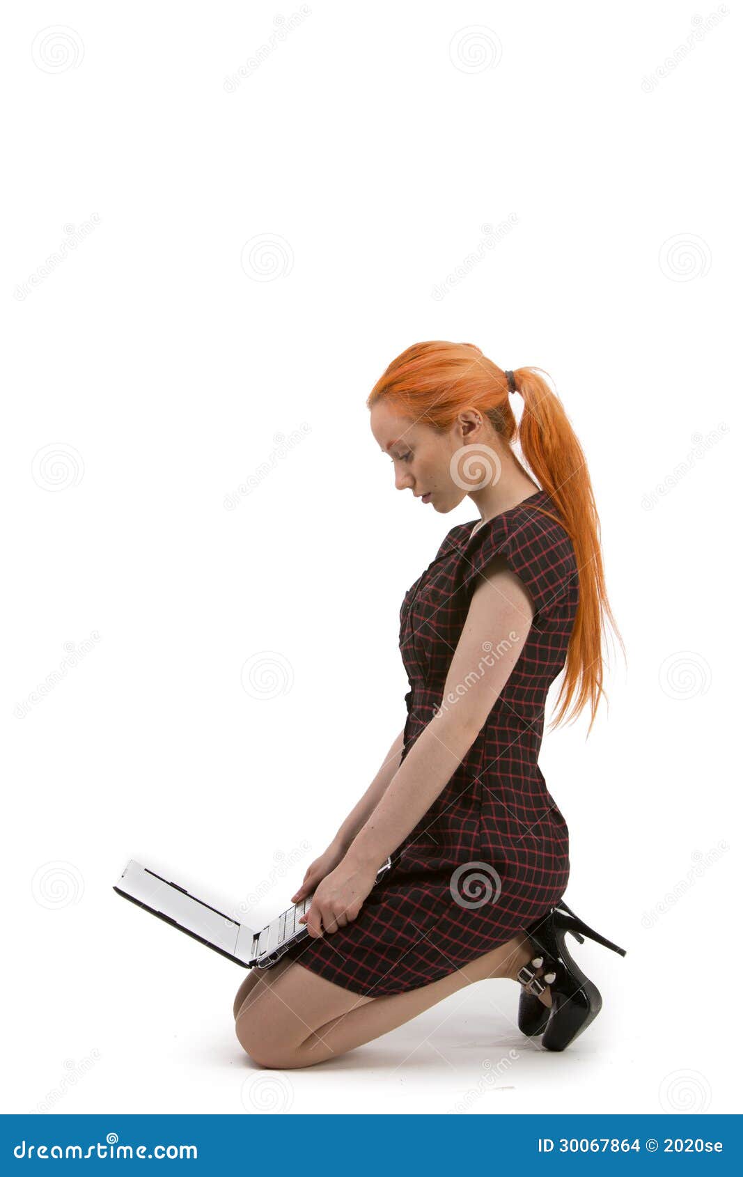 Woman Kneeling Reading Her Laptop Stock Photo - Image 