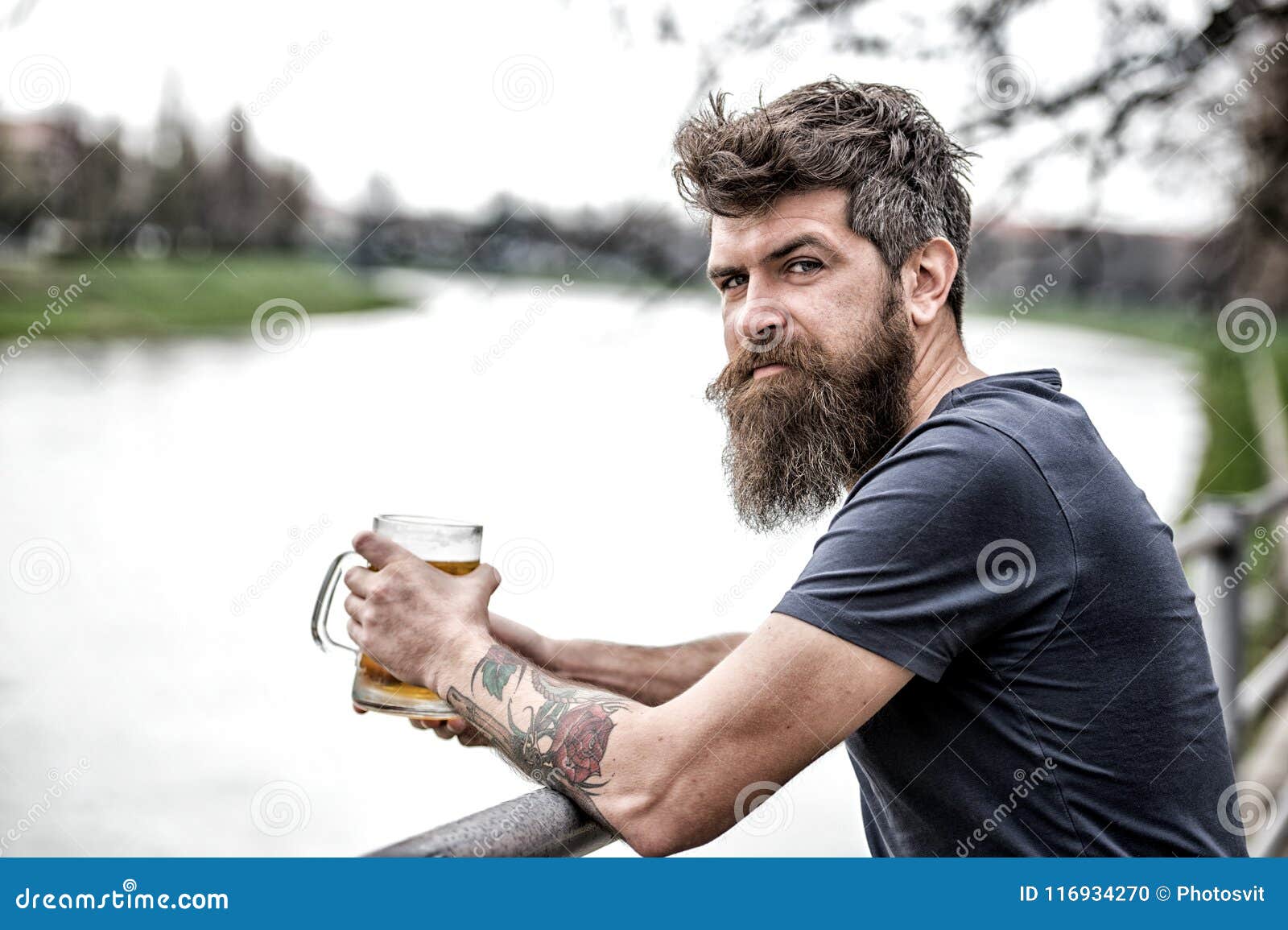 Side View Bearded Man Enjoying Big Mug of Beer on Warm Evening. Brutal Man  with Messy Hairstyle and Tattooed Arm Having Stock Photo - Image of  brewery, hairstyle: 116934270