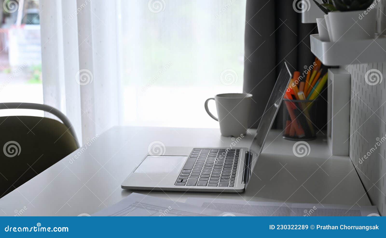 Computer Laptop, Coffee Cup and Pencil Holder on White Table. Stock