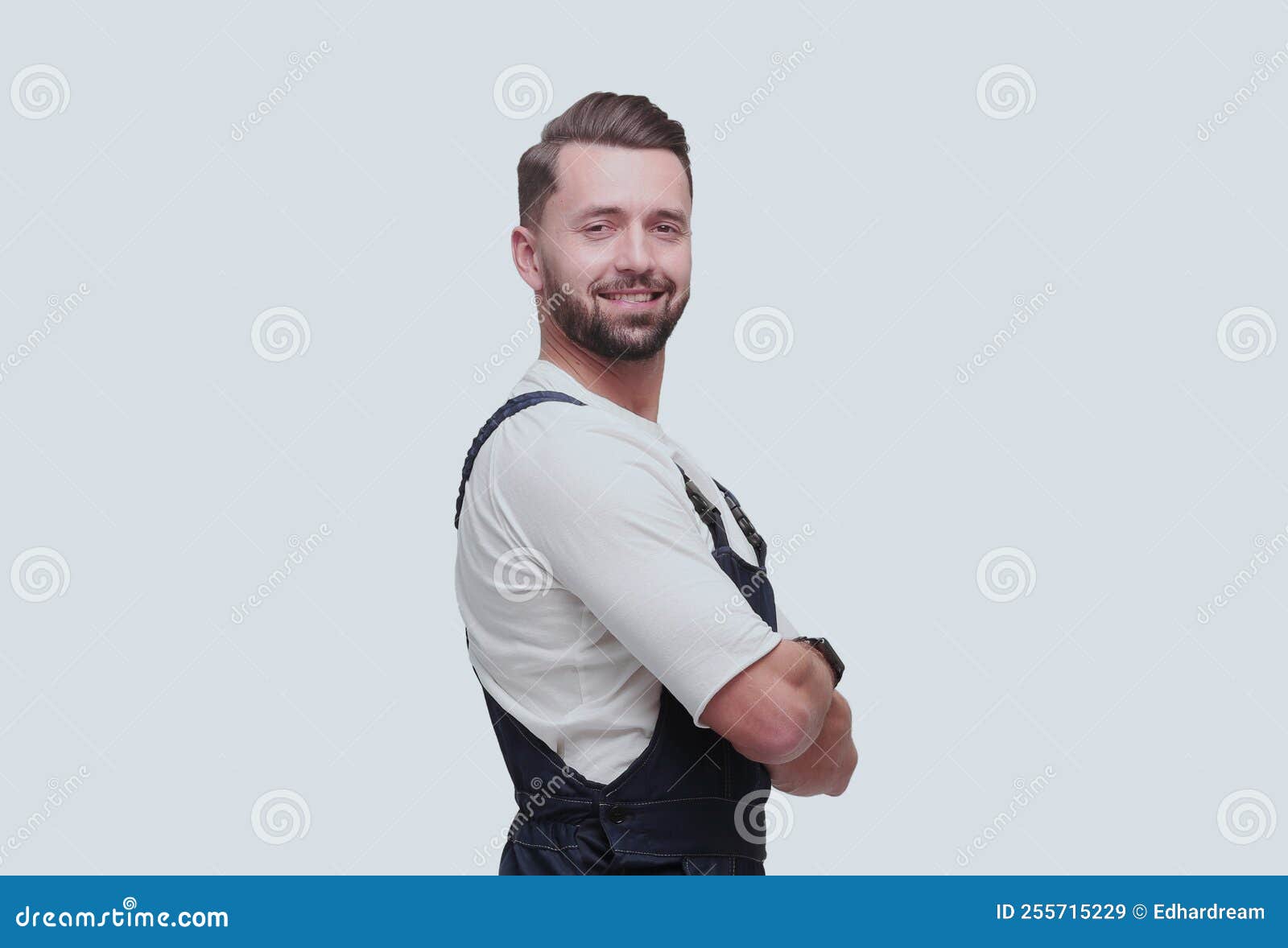 Side View. Confident Man in Overalls Looking Forward Stock Image