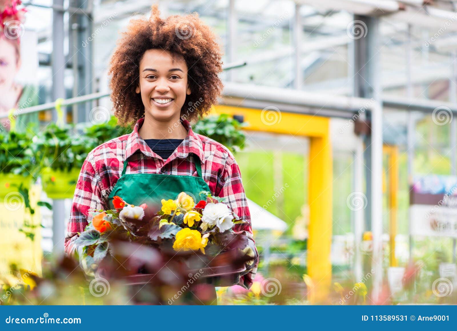 side view of a dedicated florist holding a tray with decorative flowers