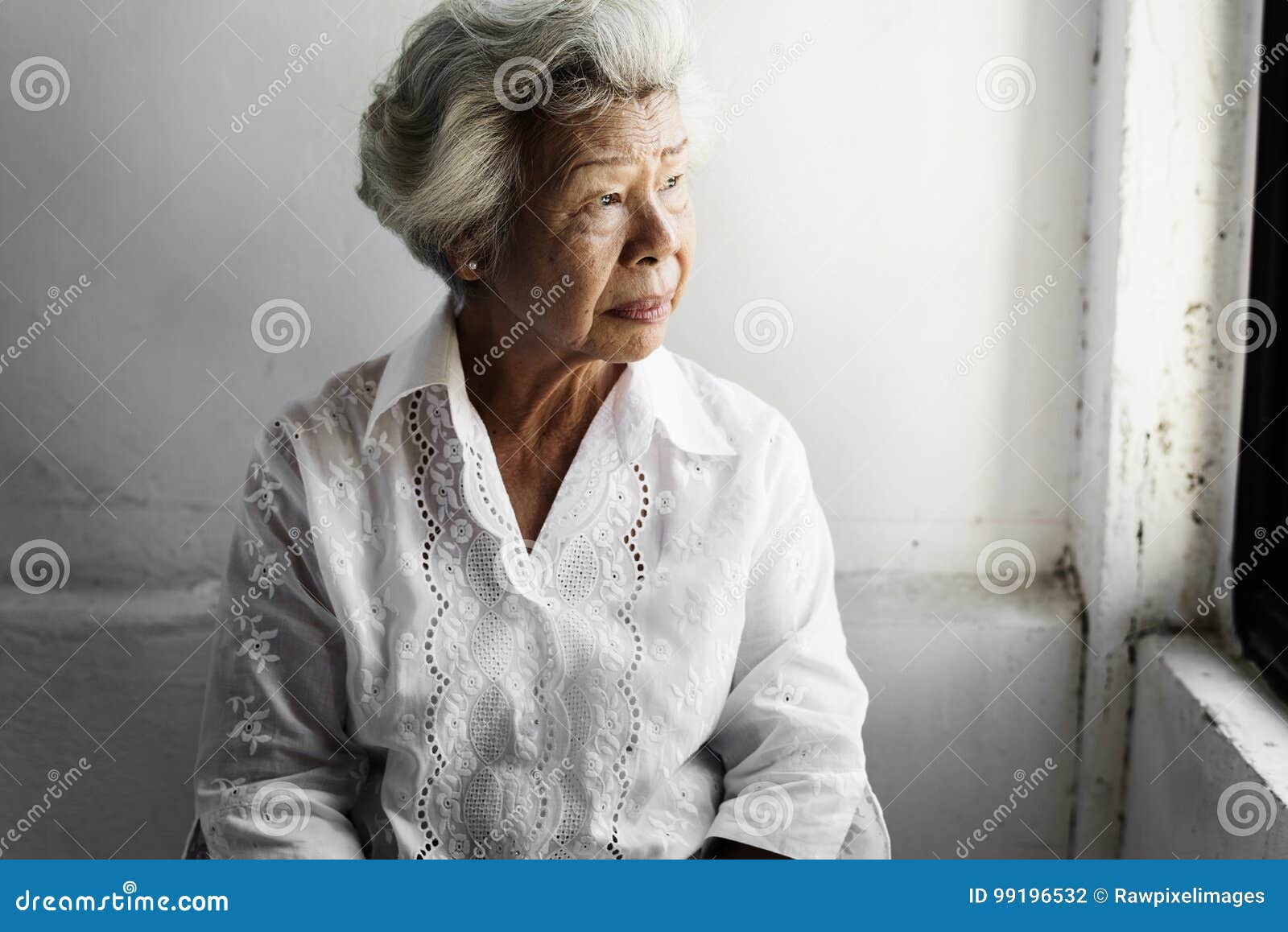 side view of elderly asian woman with thoughtful face expression