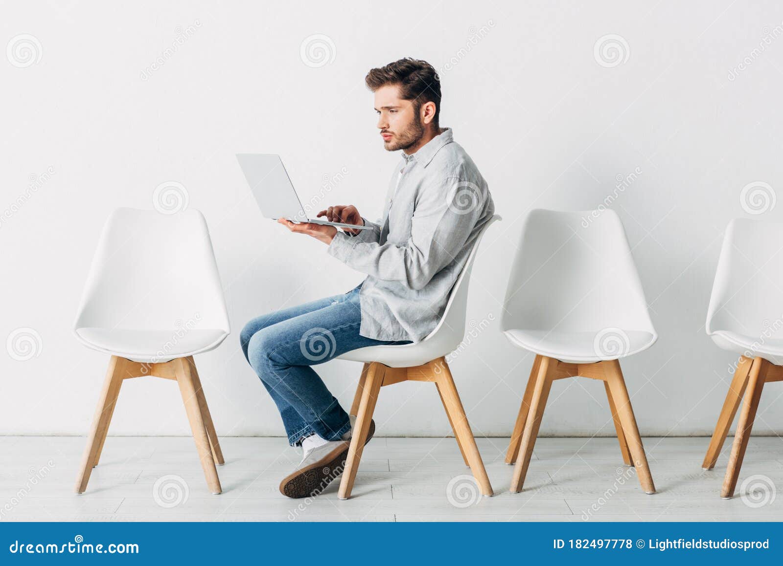 Side View of Employee Using Laptop on Chair Stock Photo - Image of ...