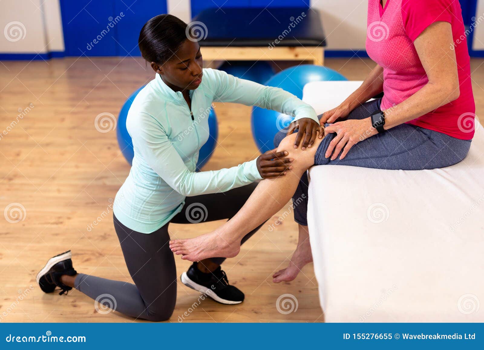 Female Physiotherapist Giving Leg Massage To Active Senior Woman In 