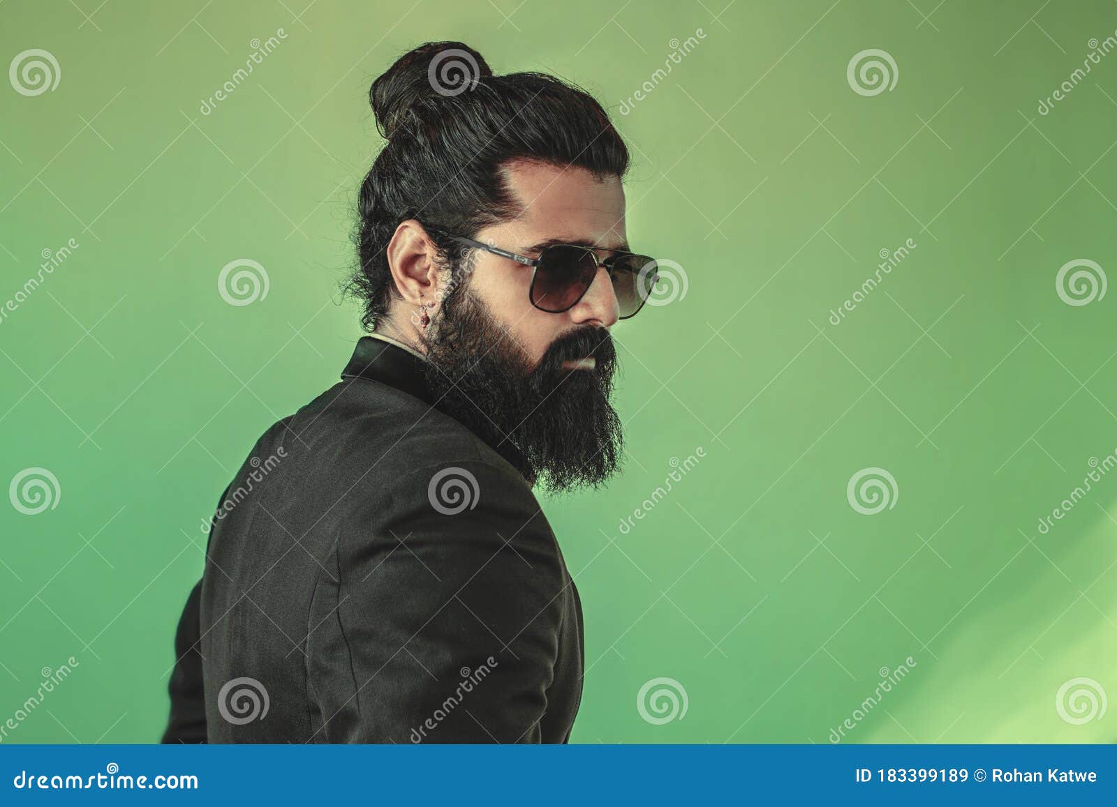 Side View of Handsome Bearded Man from the Back with a Man Bun Hairstyle  Posing in Studio Wearing a Suit and Sunglasses on Green Stock Image - Image  of handsome, long: 183399189