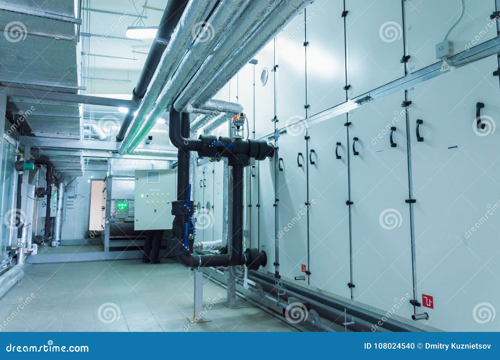 side view of the huge gray industrial air handling unit in the ventilation plant room