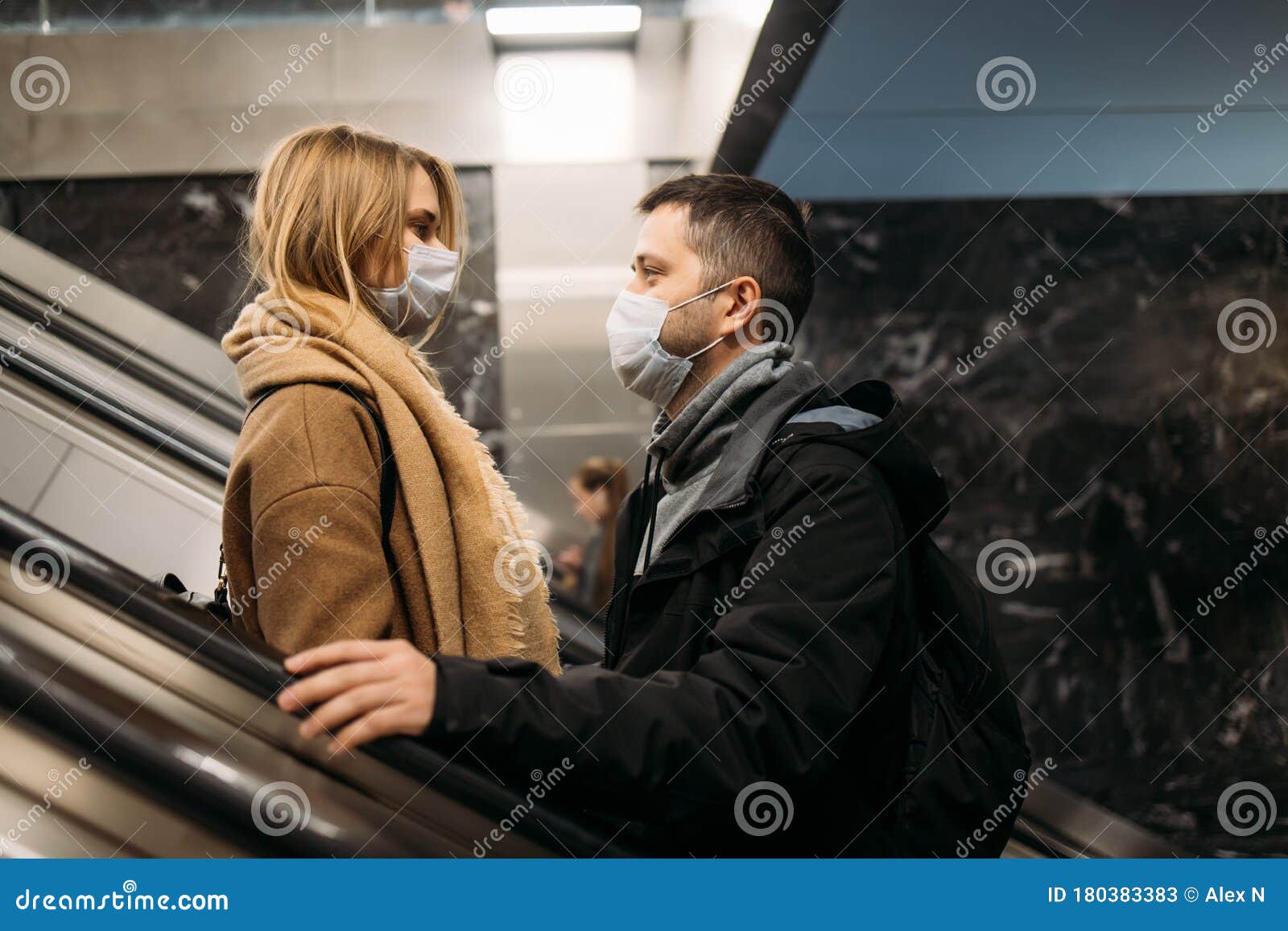 Side View of Hugging Man and Woman in Medical Masks on Escalator in ...