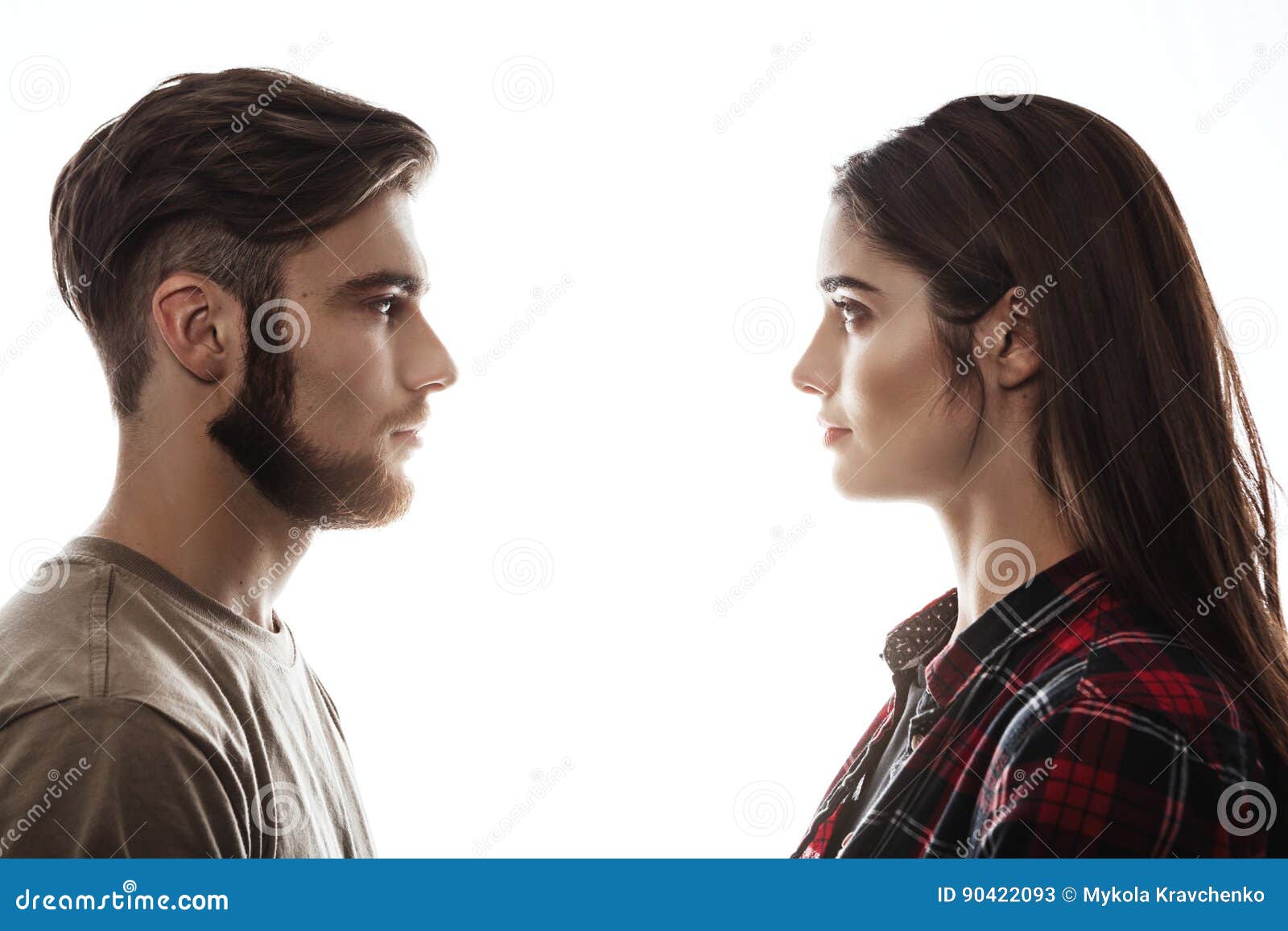 side view. man and woman facing each other, eyes open.