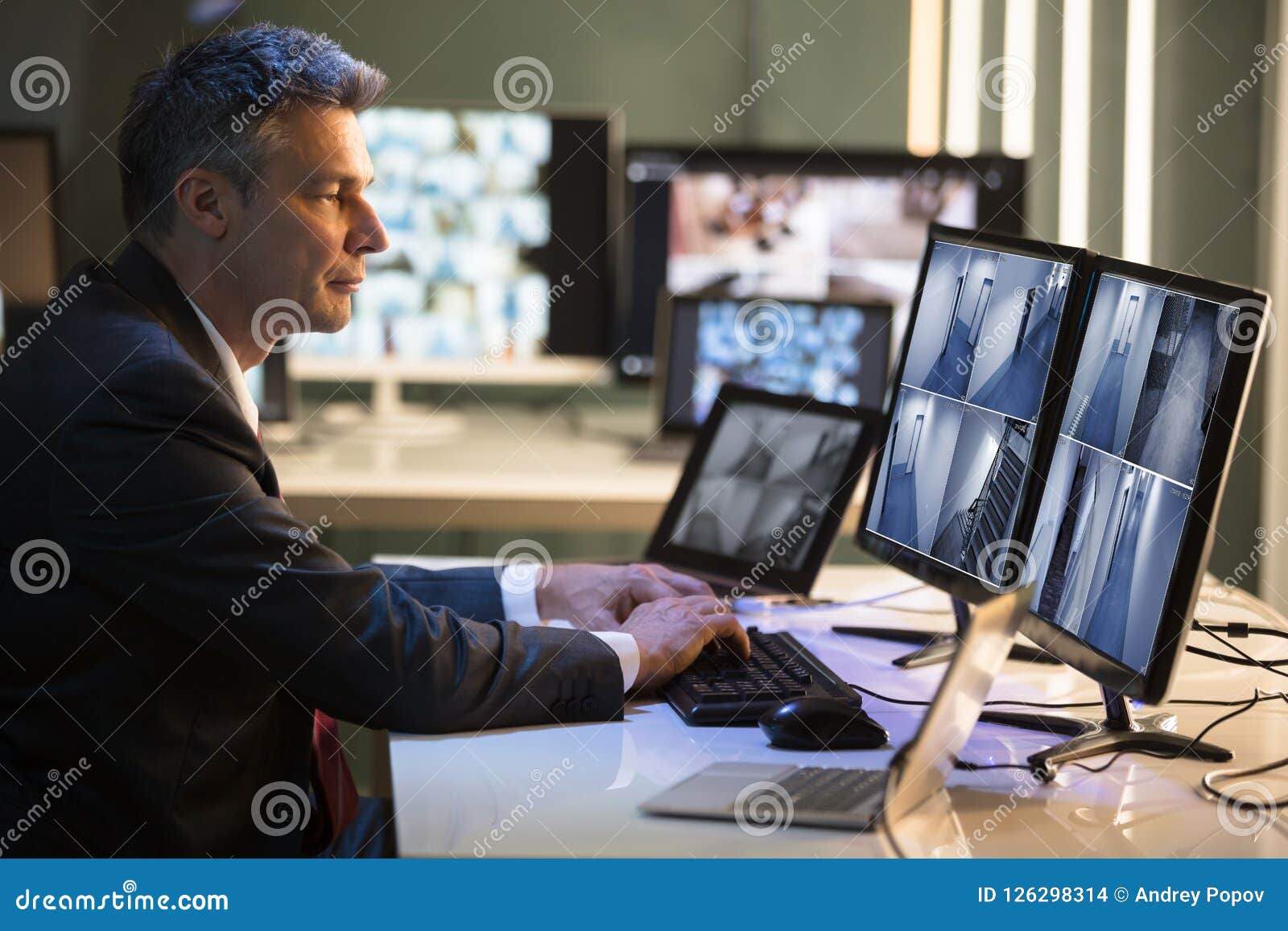 businessman looking at cctv camera footage