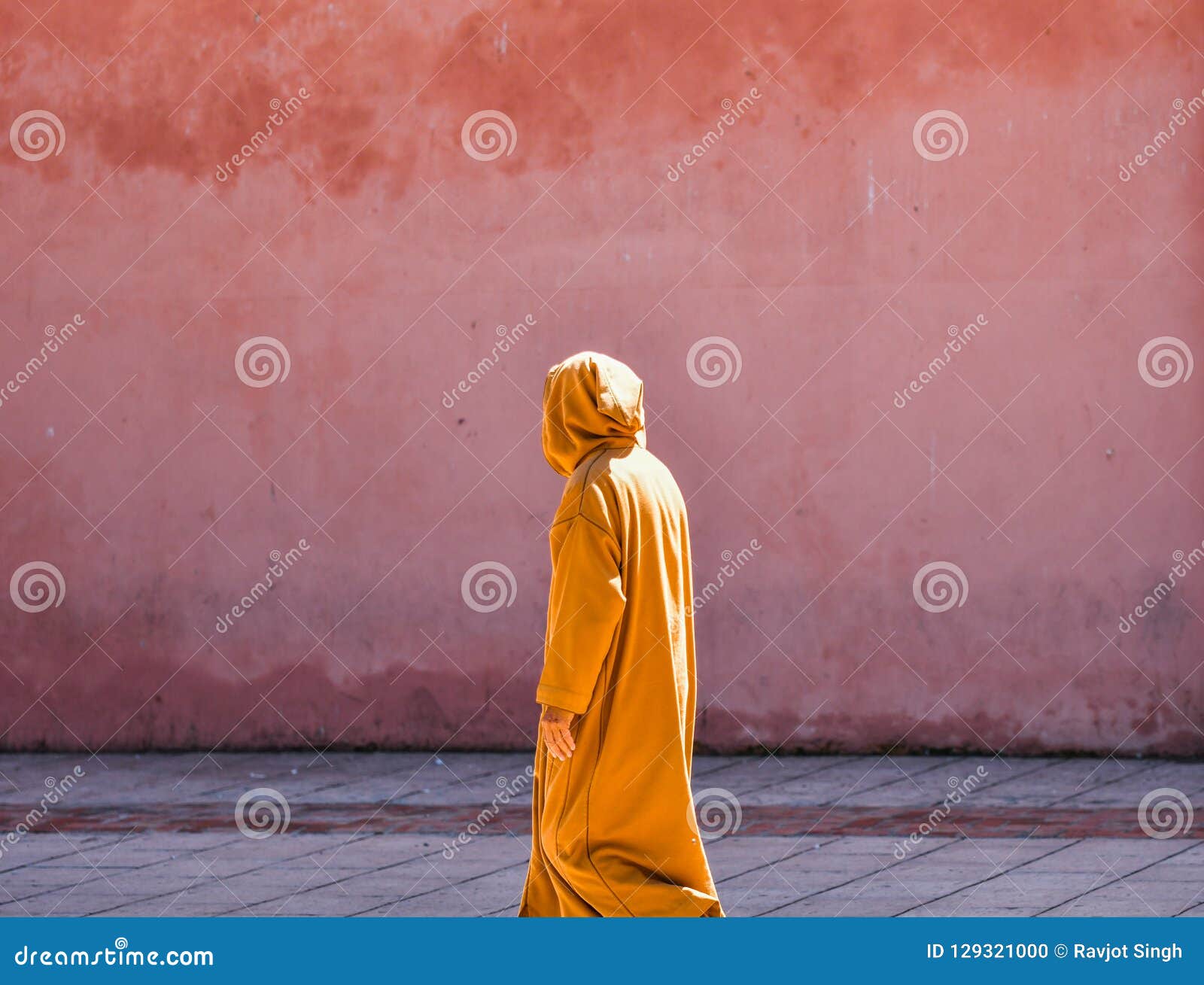 Download Side View Of A Person Wearing Long Sleeved Yellow Dress With Hoodie, Standing In Front Of A Wall ...