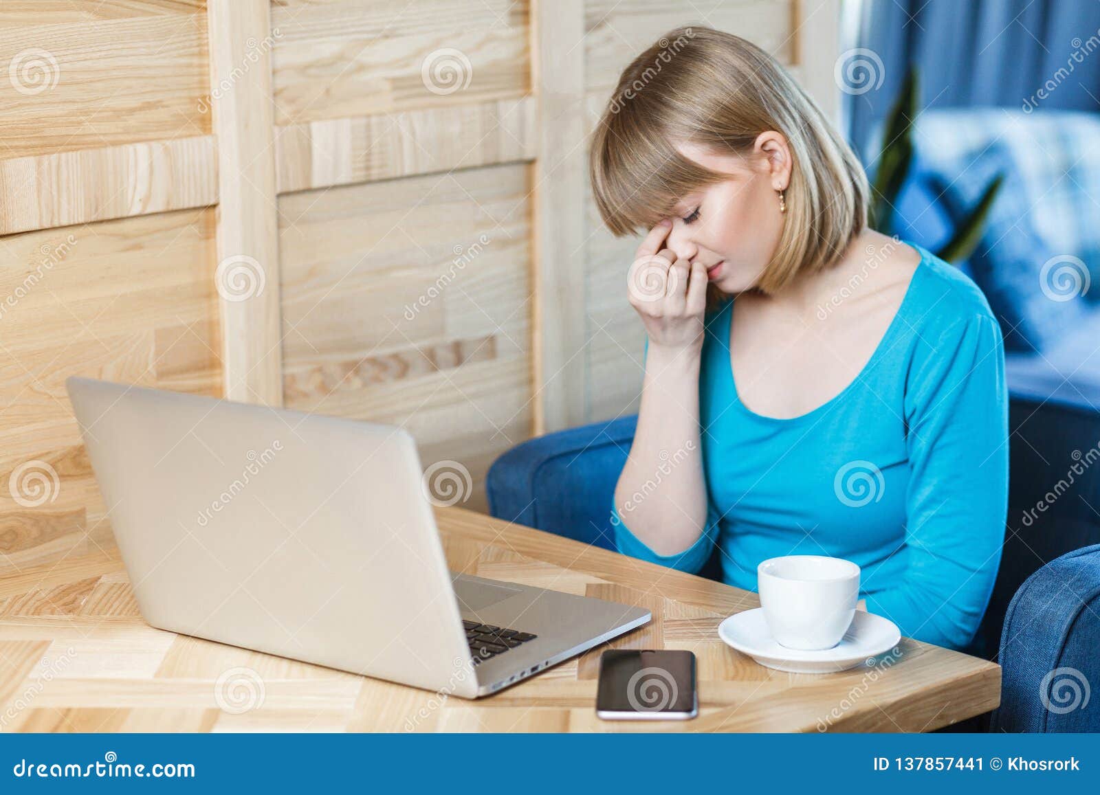 Side View Portrait Of Sad Young Girl Freelancer With Blonde Bob