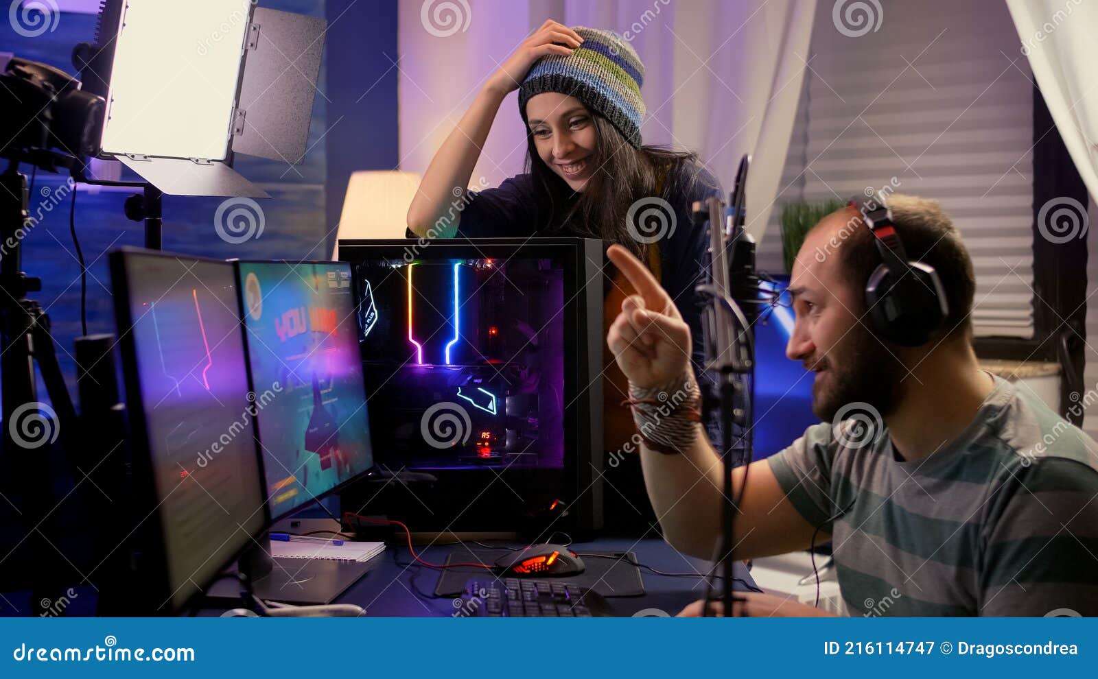 Side View of Pro Streamer Couple Performing Online Video Games Stock
