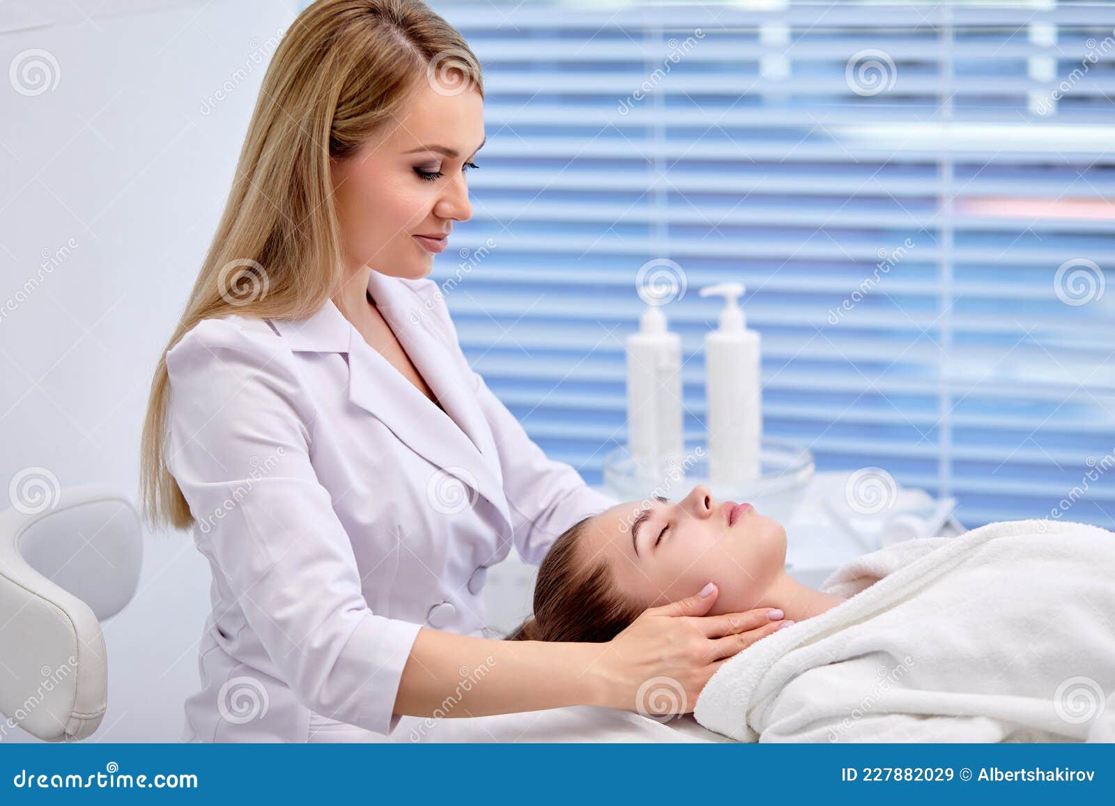 Side View On Professional Confident Cosmetologist Massaging Womanand X27s Client Face Stock Image