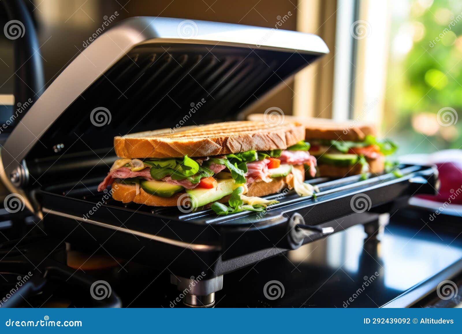 Side View of Sandwich Under a Hot Iron Press on Stove Stock Photo