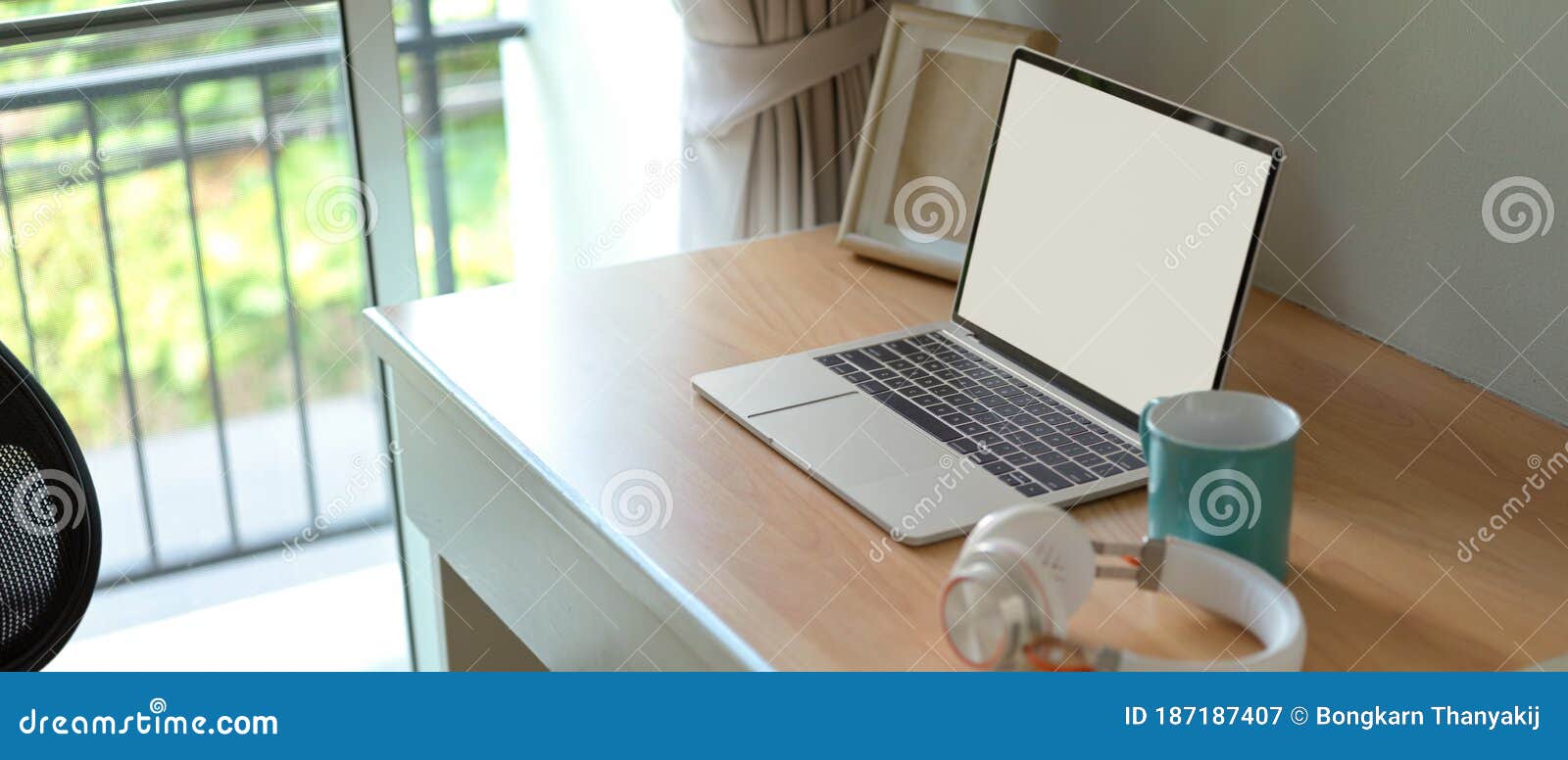 Simple Worktable with Blank Screen Laptop, Mock-up Frame, Headphone and