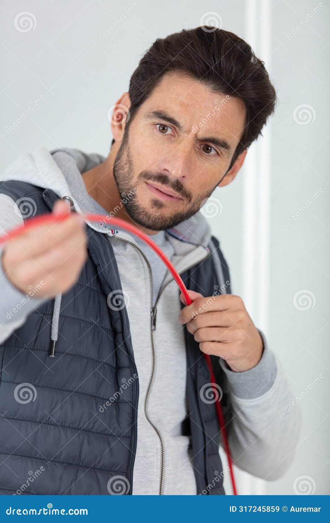 side view smiling handsome electrician repairing electrical wire