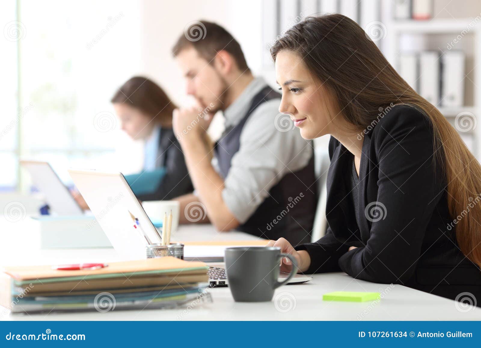three office workers working