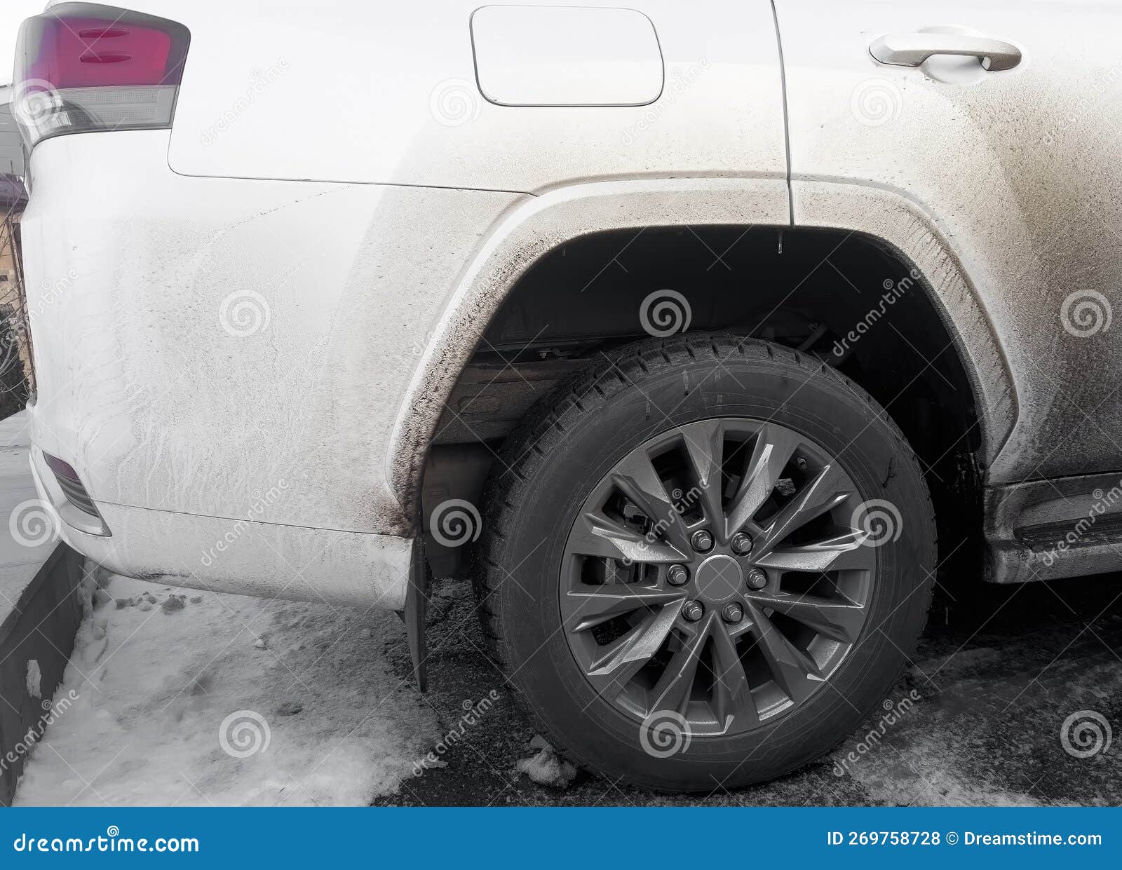 side view of a very dirty car. fragment of a dirty suv. dirty headlights, wheel and bumper of the off-road car with swamp splashes