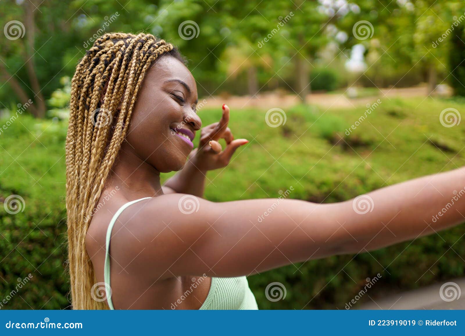 Close-up View Of An African-American Woman With Closed Eyes Taking A Selfie Doing Peace Sign ...