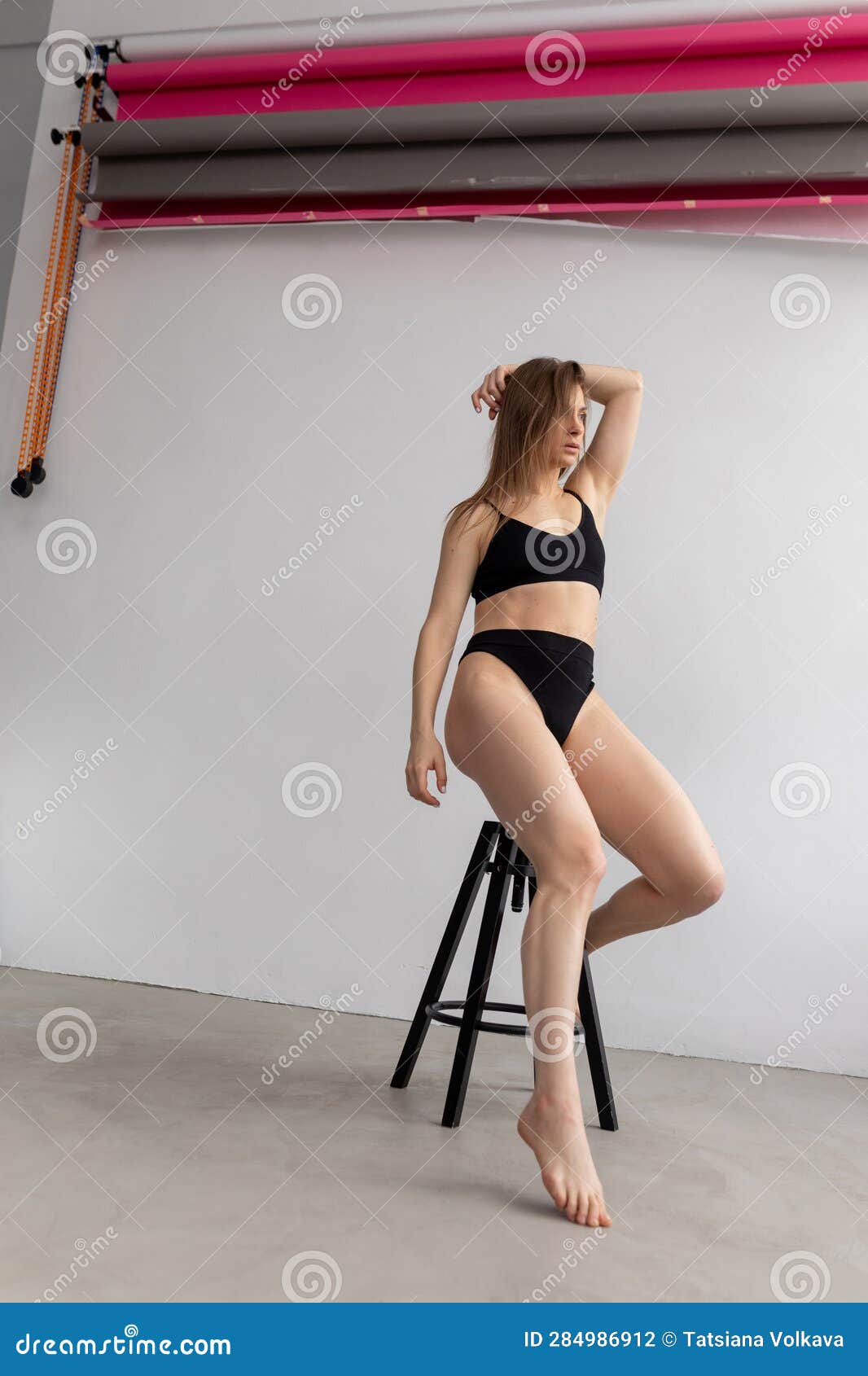 Side View of Young Attractive Woman with Long Dark Hair Wearing Black  Underwear Bra, Underpants, Sitting on Black Stool. Stock Photo - Image of  perfect, female: 284986912