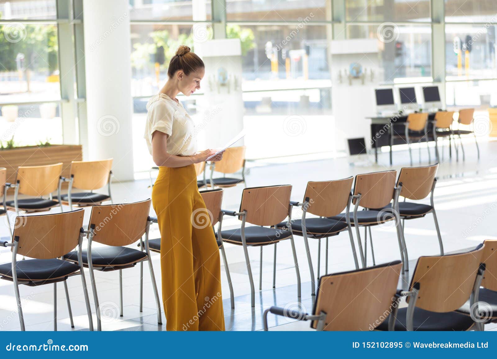 Caucasian Female Executive Looking At Documents While