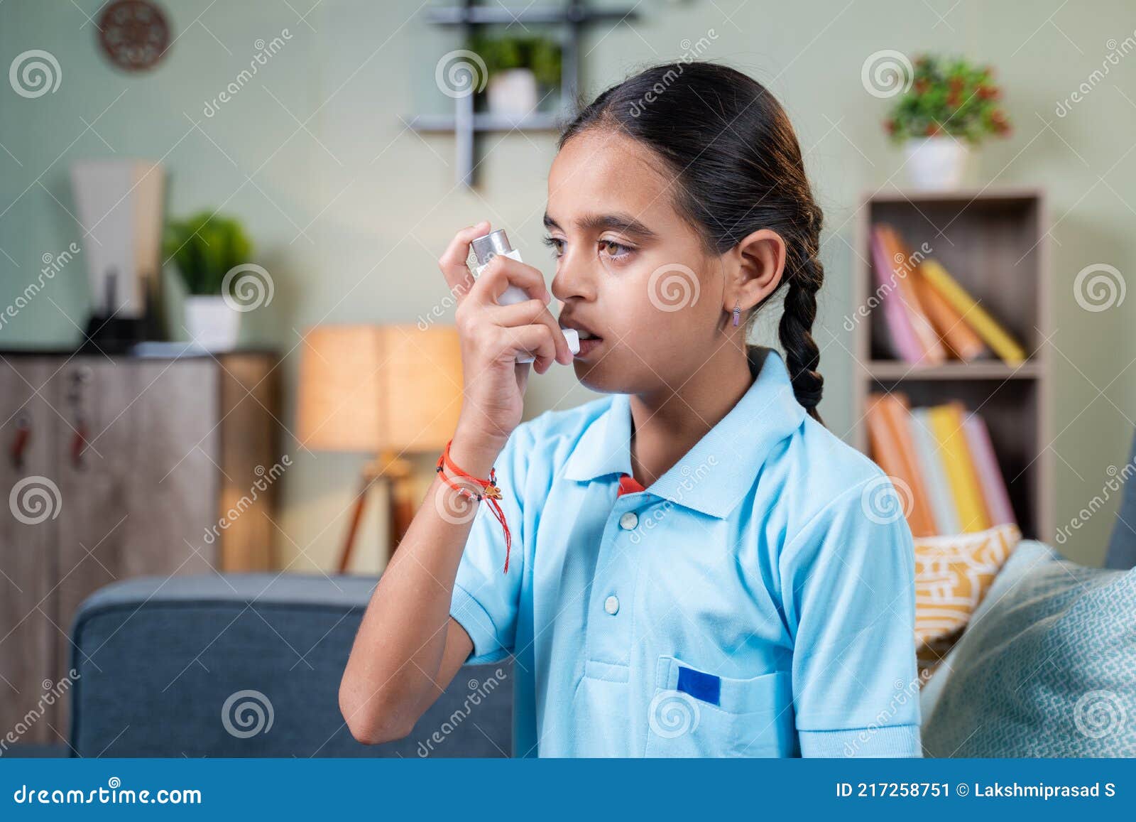 side view young girl kid using asthma medication inhaler after taking deep breath - concept of asthmatic teenager kids