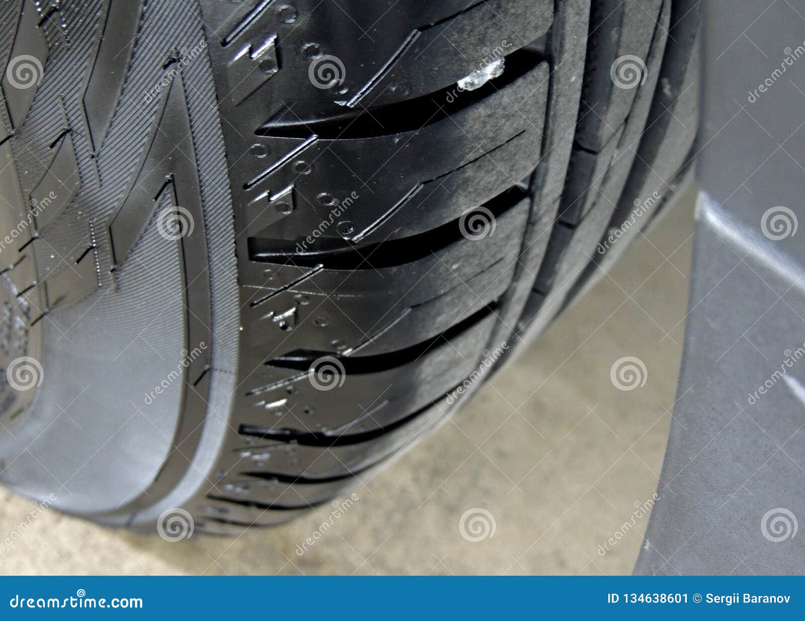 polished sidewall of car tire on the alloy wheel rim close up