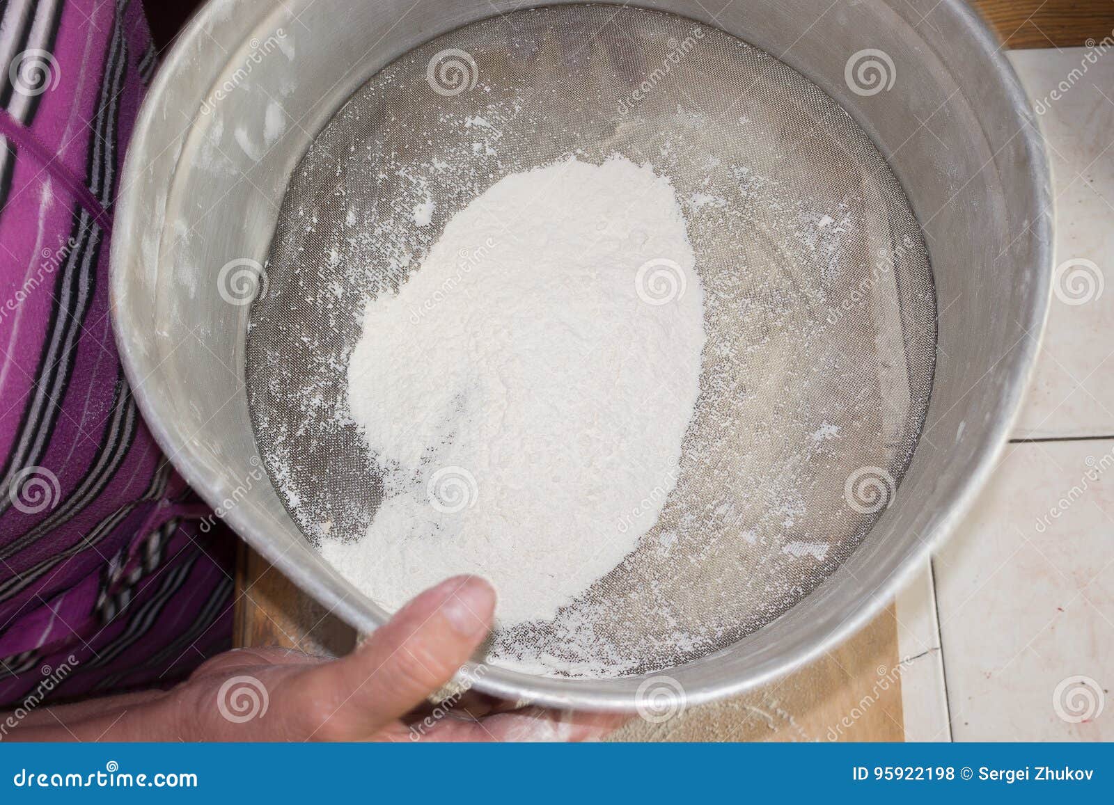 Sifting the Flour in a Sieve. Stock Photo Image of cooking, food
