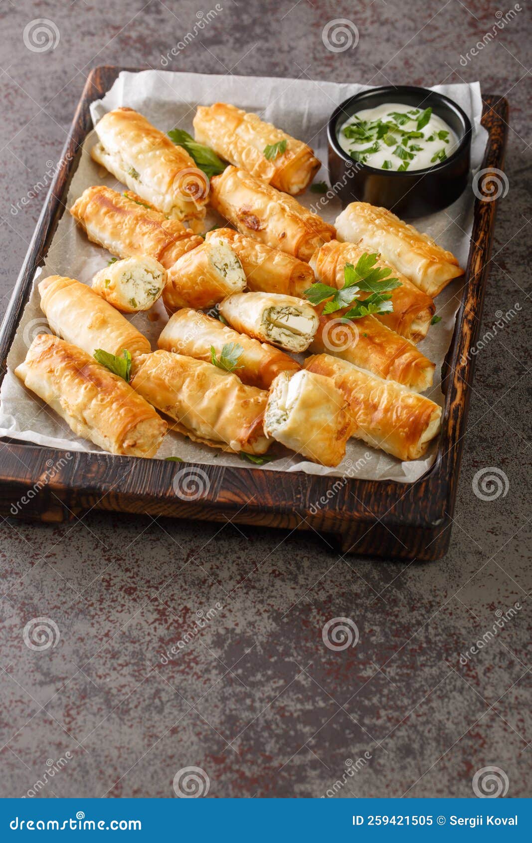 sigara boregi is a famous turkish deep-fried pastry crispy rolls of thin dough are stuffed with a creamy mixture of cheese and
