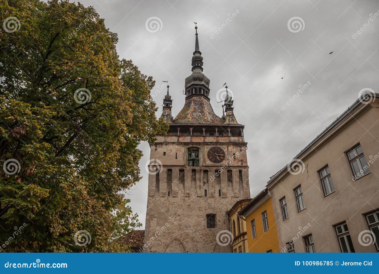 sighisoara clock tower turnul cu ceas during a cloudy fall afternoon. it is the main entrance of sighisoara castle, in romania