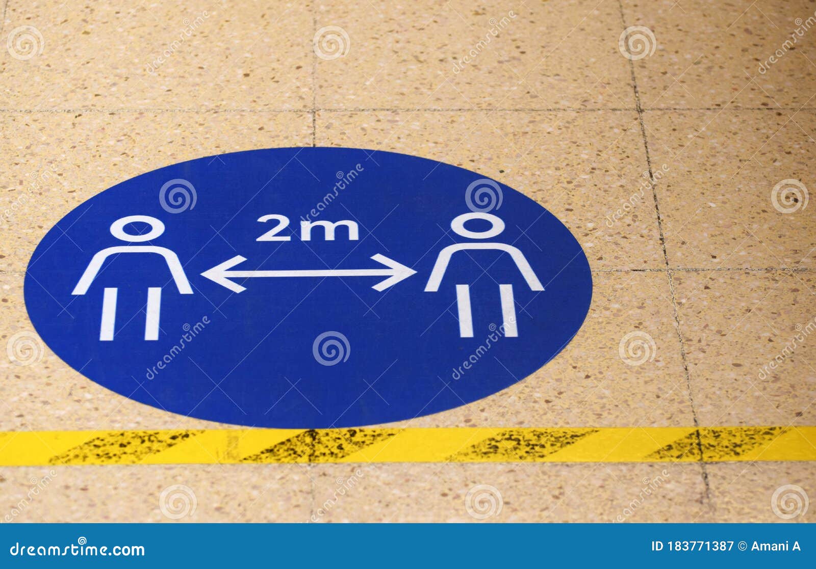 a sign / marker on a grocery supermarket shop floor showing the social distancing spacing of 2 metres
