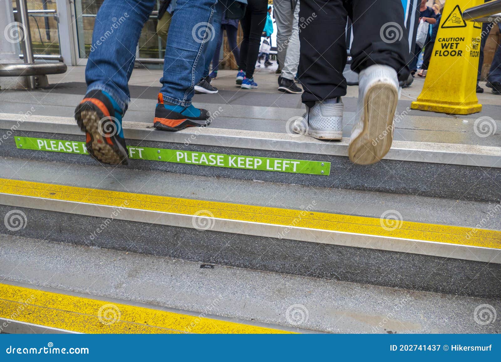 sign on a staircase in english, please keep left