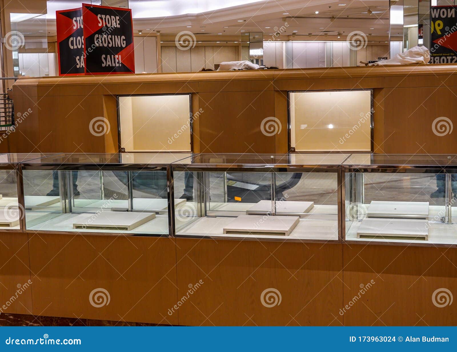 Sign for a Store Closing Sale on Top of an Empty Jewelry Display Case 