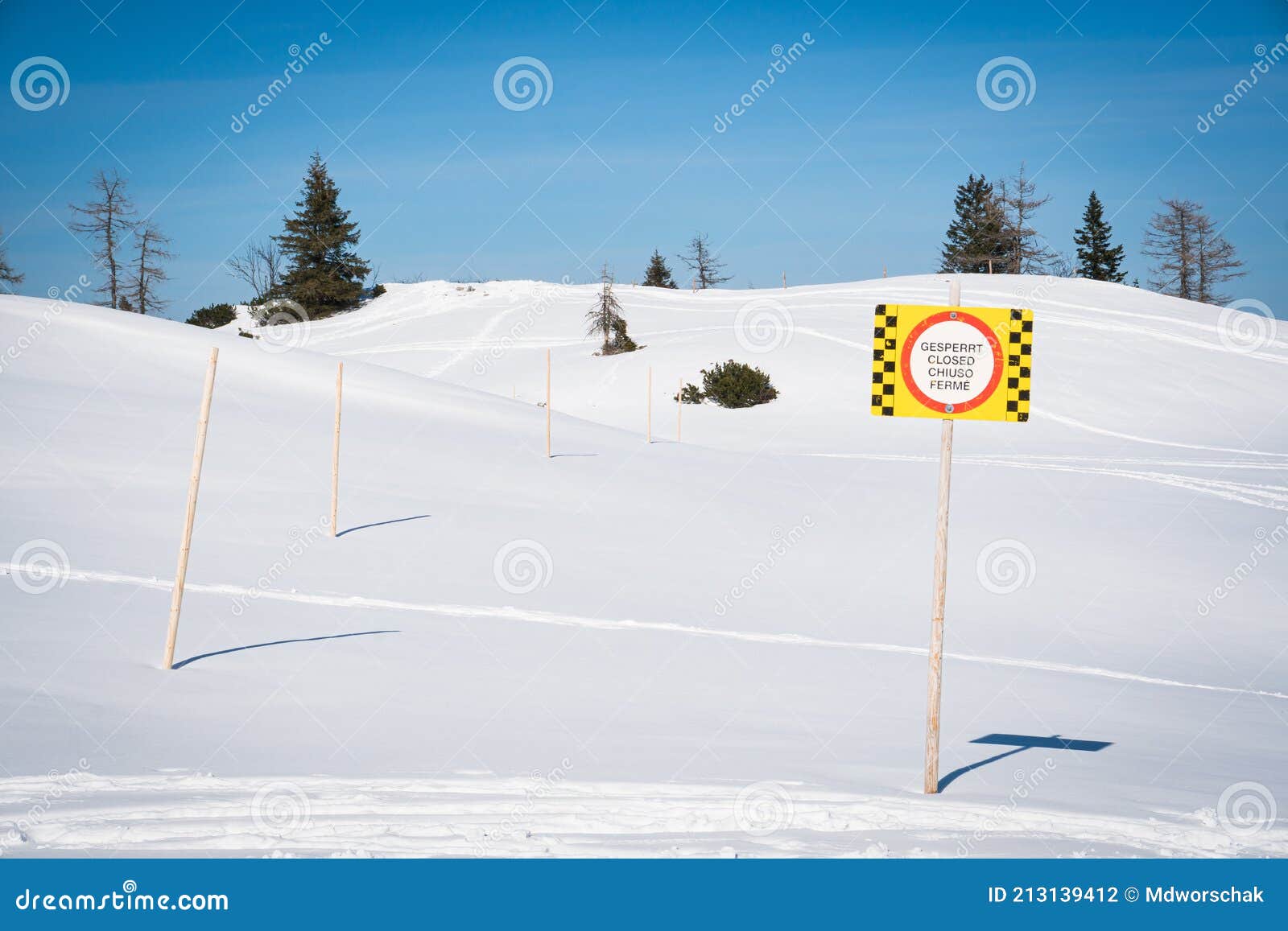 sign warning of closed skiing area due to avalanche or other danger