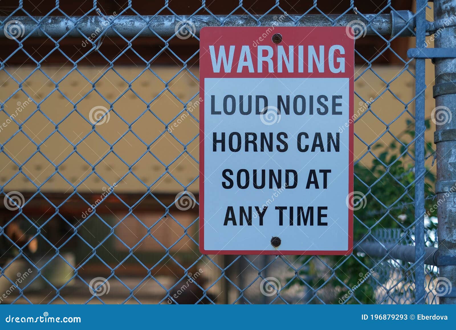 sign warning loud noise horns can sound at any time on the fence at port.