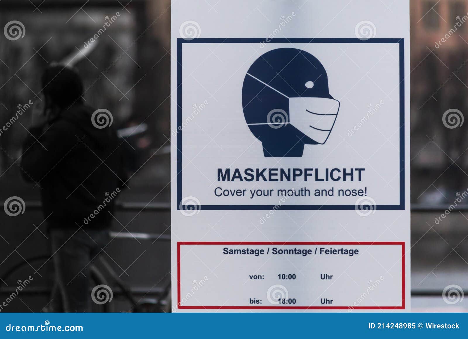 Sign on a Window Saying Face Mask Requirement in German Stock Image