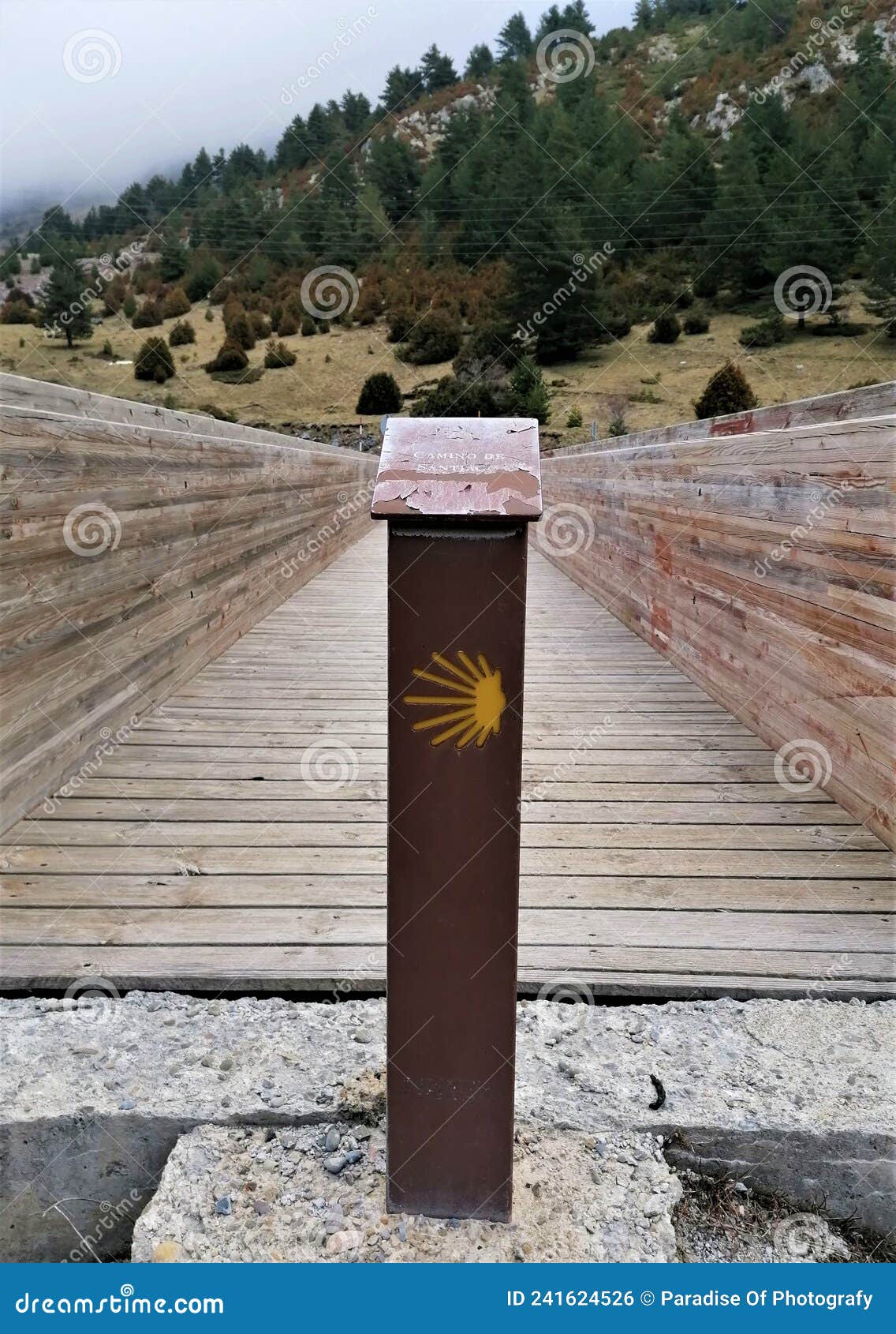 camino de santiago mark before crossing a wooden bridge