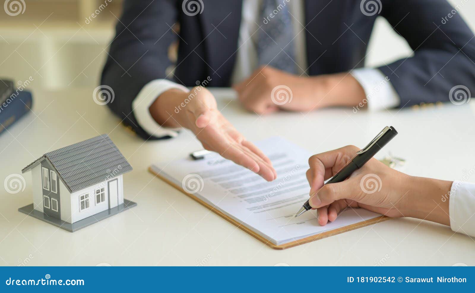 Signing a Home Purchase Contract between the House Broker and the Client Stock Photo Image of