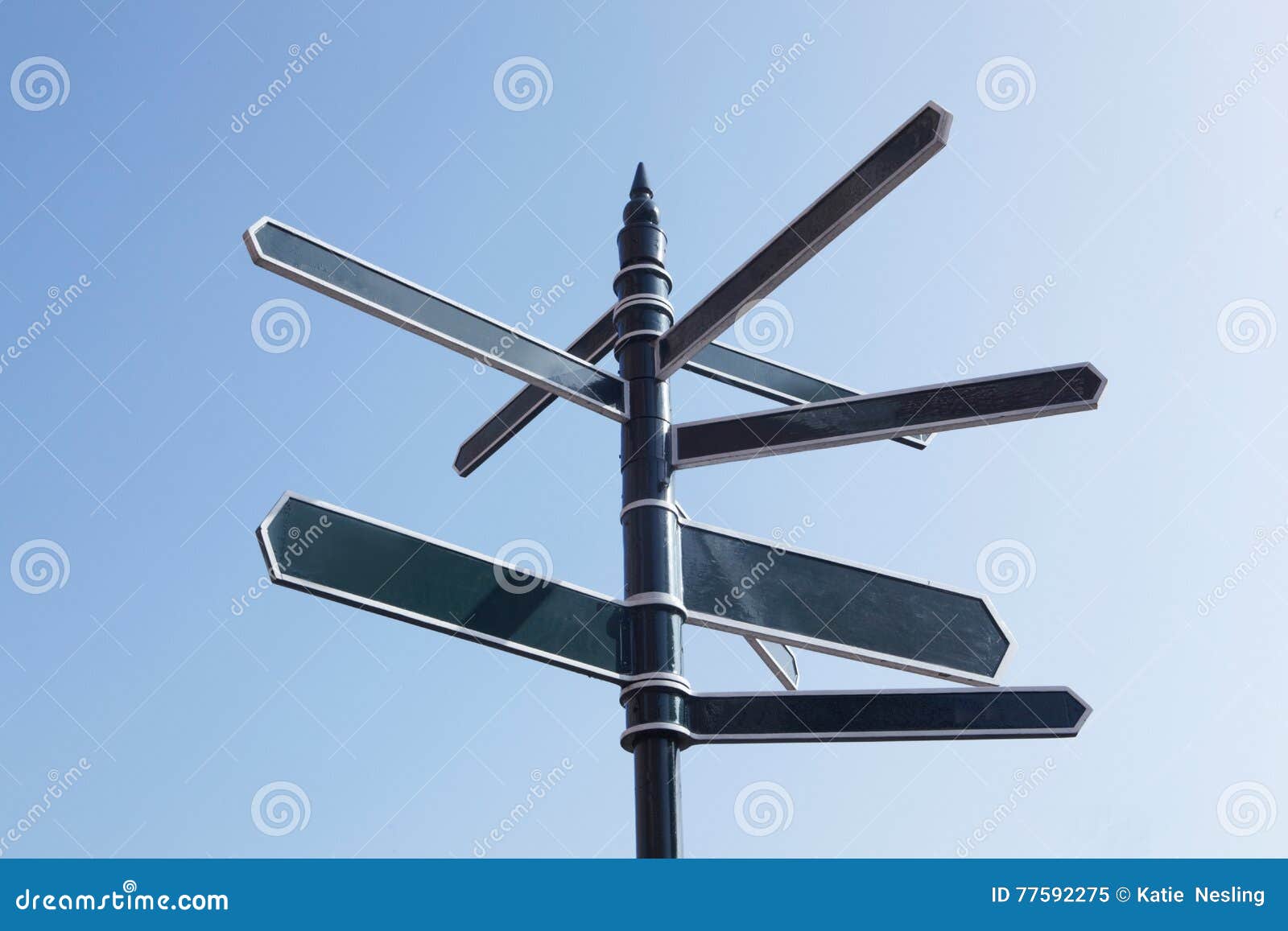 signpost pointing in many directions against blue sky