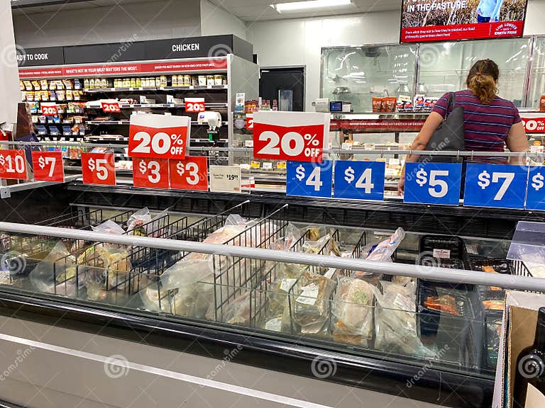 Signs and Empty Shelves in the Meat Aisle of an Earthfare Grocery