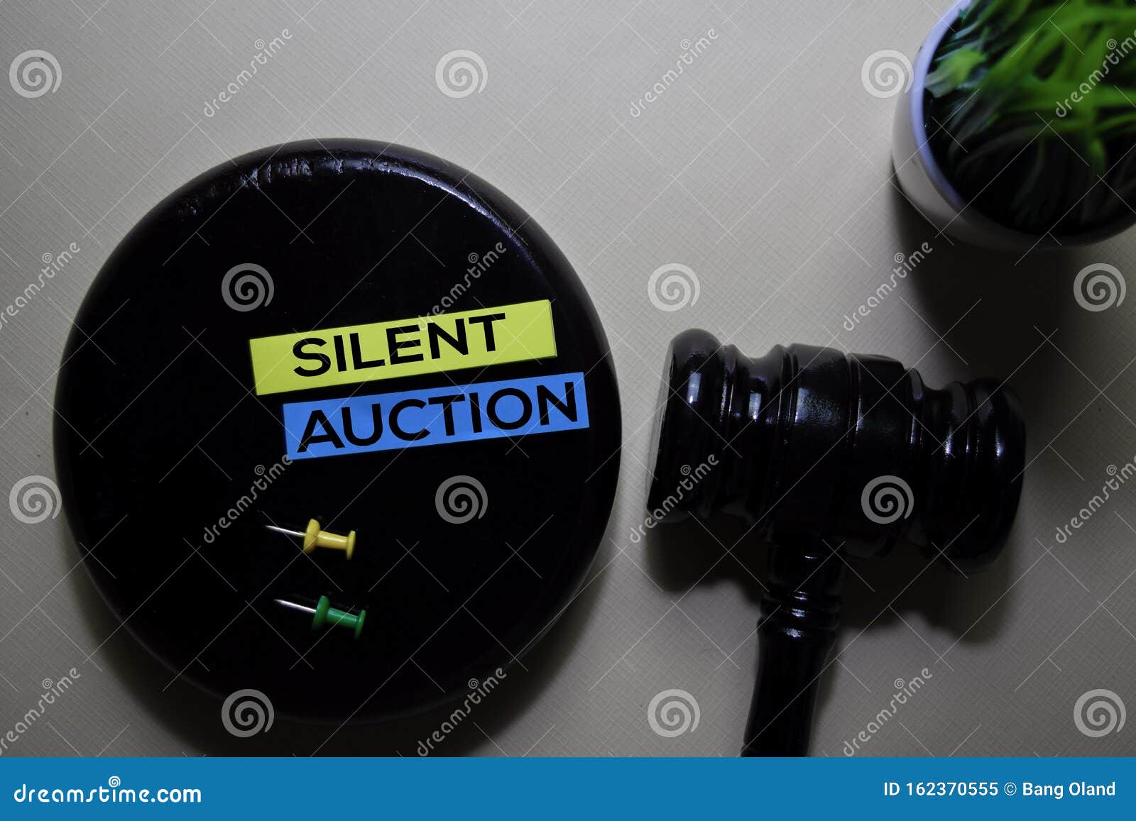 silent auction text on sticky notes and gavel  on office desk. justice law concept
