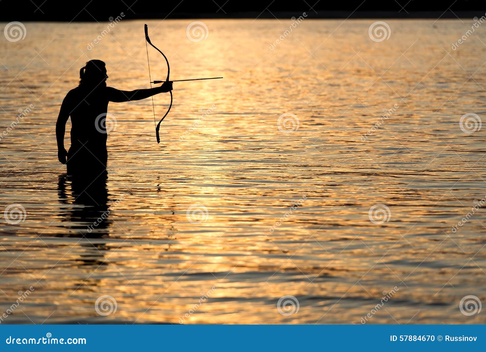 Silhouette Archery Shoots a Bow at a Target in Sunset Sky Stock Photo