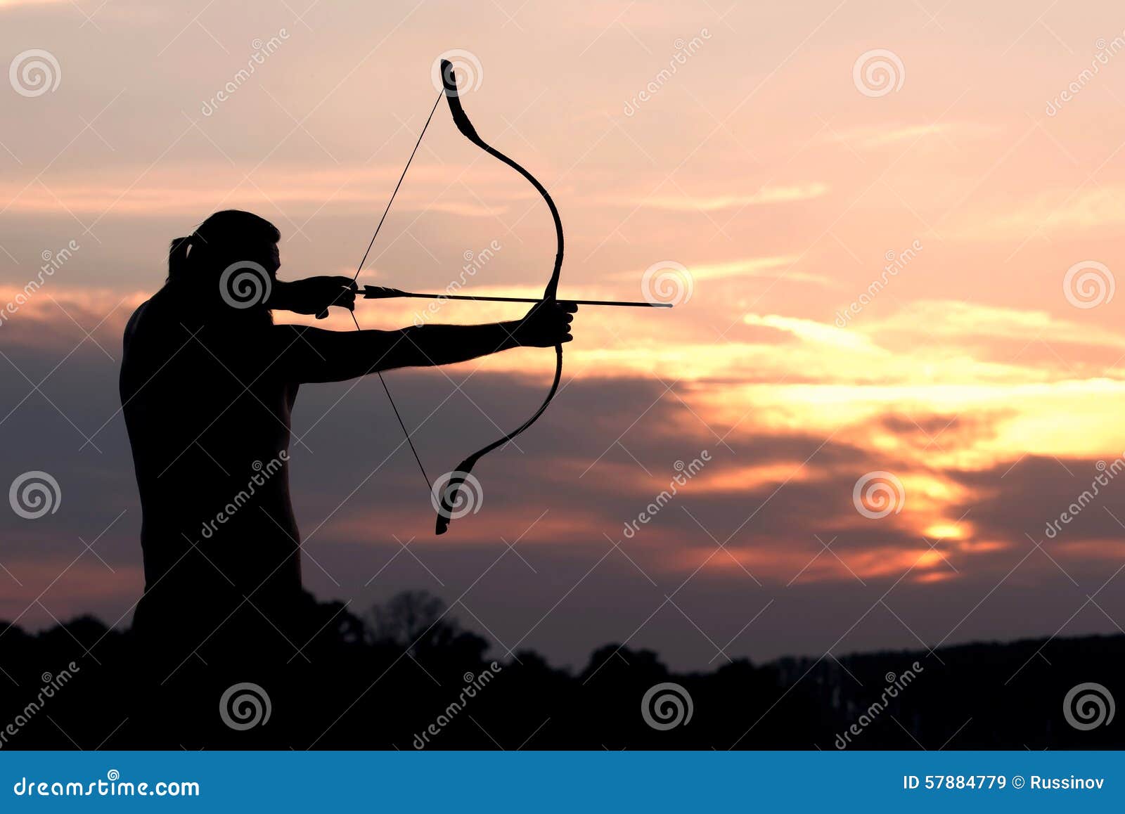 Silhouette Archery Shoots a Bow at a Target in Sunset Sky Stock Image